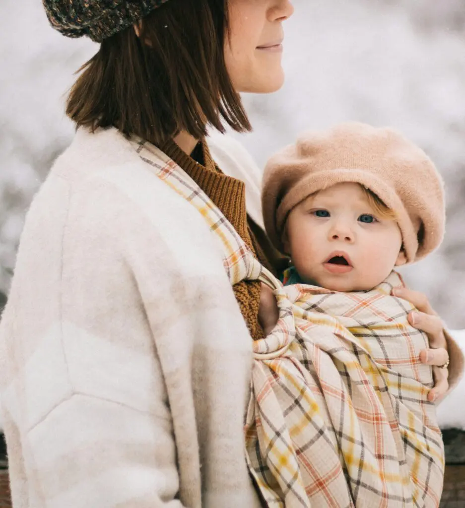 baby's first winter going for a walk outside in a sling